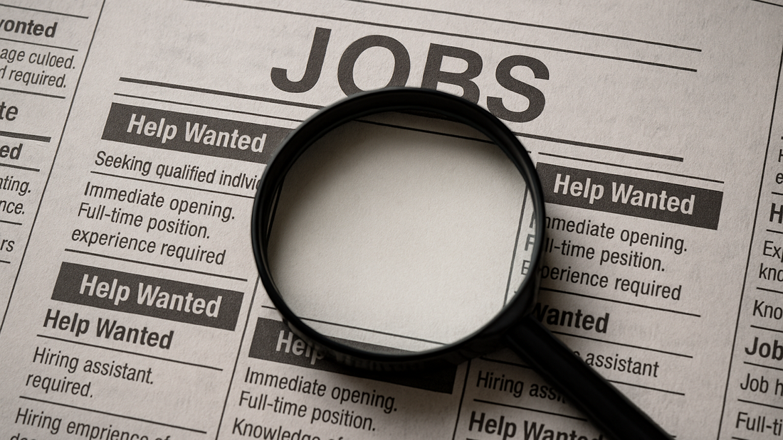 A help wanted section in a newspaper with a magnifying glass pointing to a blank job ad symbolizing ghost jobs.